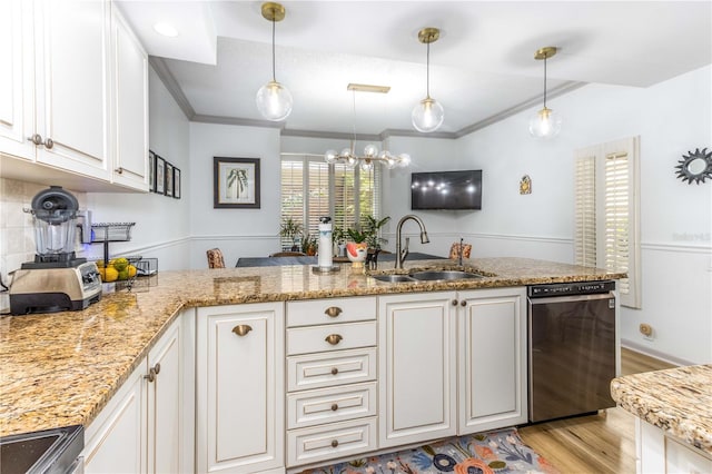 kitchen with appliances with stainless steel finishes, sink, white cabinetry, and pendant lighting