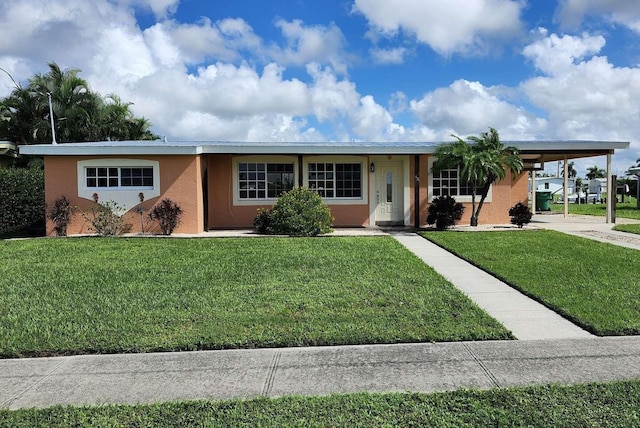 single story home featuring a front lawn and a carport