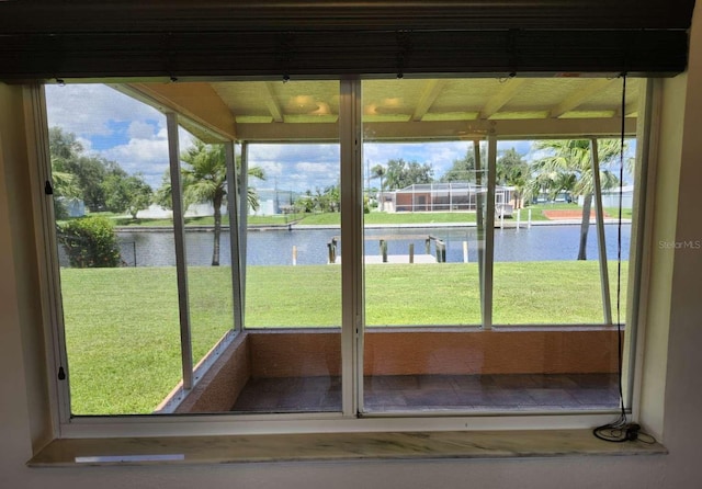 unfurnished sunroom with a healthy amount of sunlight and a water view