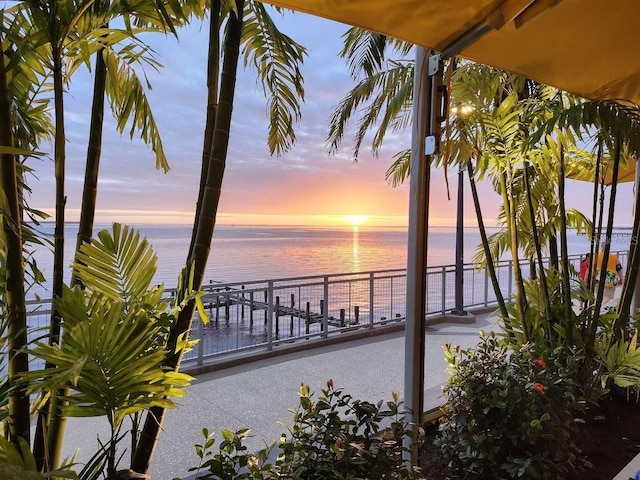 patio terrace at dusk with a balcony and a water view