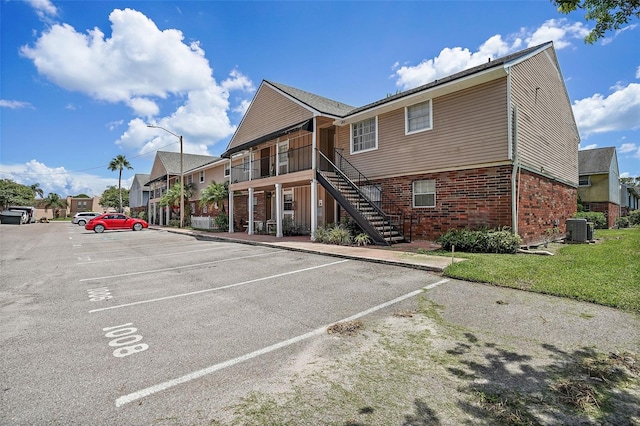 200 Country Club Dr Unit 1004, Largo, FL 33771 - exterior space featuring stairs, cooling unit, and uncovered parking