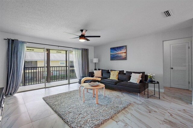 200 Country Club Dr Unit 1004, Largo, FL 33771 - living area featuring visible vents, baseboards, ceiling fan, marble finish floor, and a textured ceiling