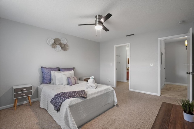 bedroom with a textured ceiling, carpet flooring, and ceiling fan