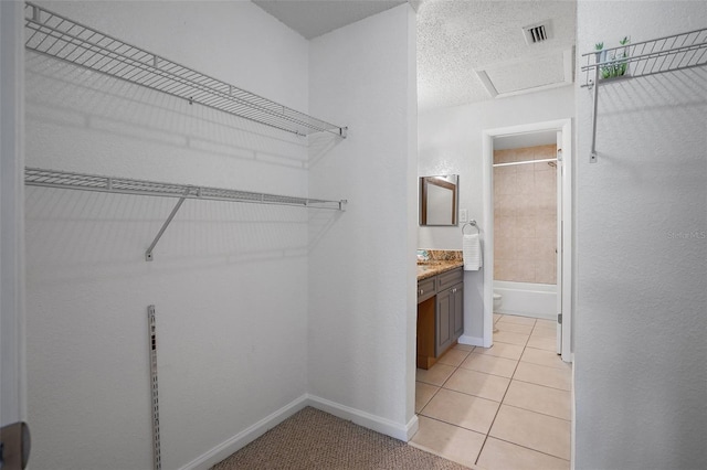 spacious closet with light tile patterned floors