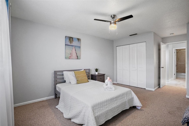 bedroom featuring a closet, a textured ceiling, ceiling fan, and carpet flooring