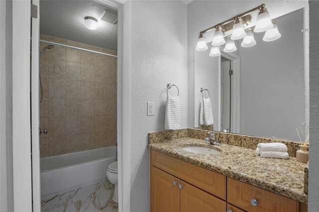 full bathroom with toilet, tiled shower / bath combo, a textured ceiling, and vanity