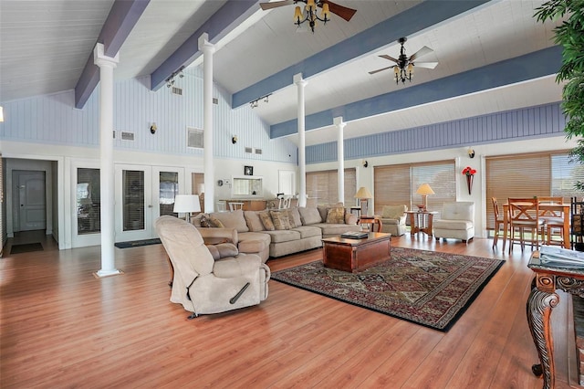 living room with ceiling fan, hardwood / wood-style floors, high vaulted ceiling, and beam ceiling