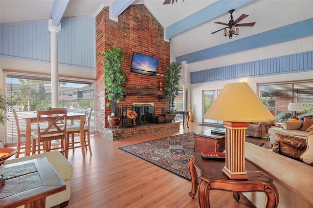 200 Country Club Dr Unit 1004, Largo, FL 33771 - living room featuring beamed ceiling, high vaulted ceiling, wood-type flooring, a fireplace, and ceiling fan