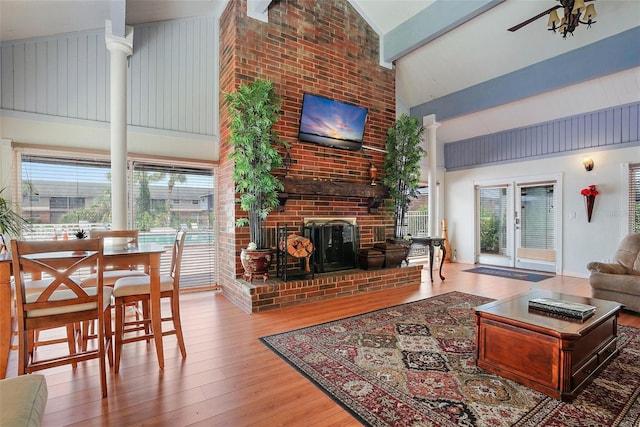 200 Country Club Dr Unit 1004, Largo, FL 33771 - living area featuring beam ceiling, high vaulted ceiling, a brick fireplace, and hardwood / wood-style flooring