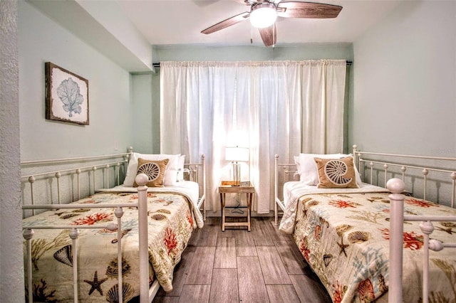 bedroom featuring dark hardwood / wood-style flooring and ceiling fan