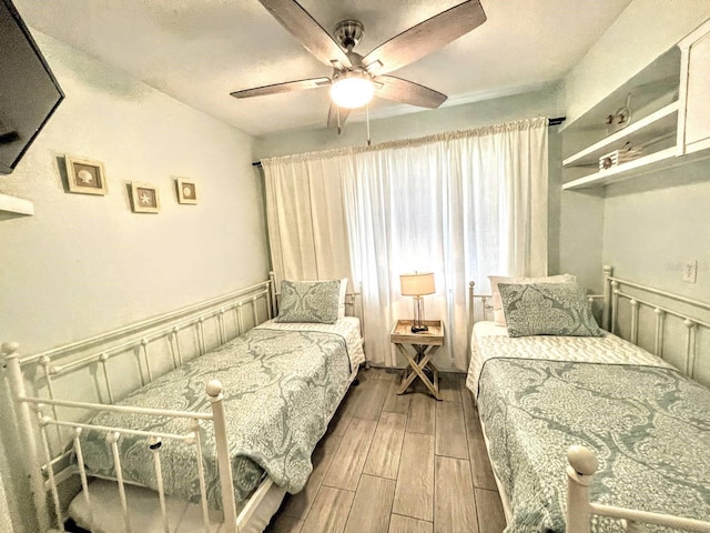 bedroom with ceiling fan and hardwood / wood-style flooring