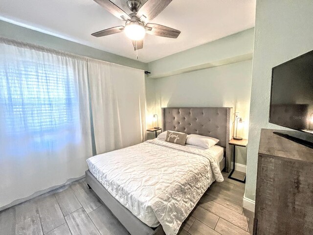 bedroom featuring ceiling fan and hardwood / wood-style flooring