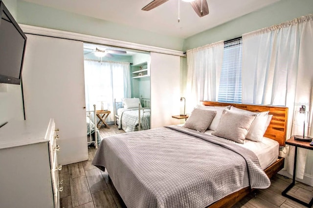 bedroom with ceiling fan and hardwood / wood-style flooring