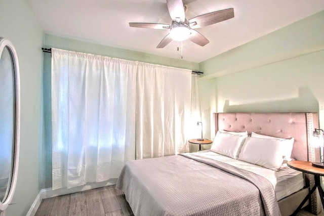 bedroom featuring hardwood / wood-style flooring and ceiling fan