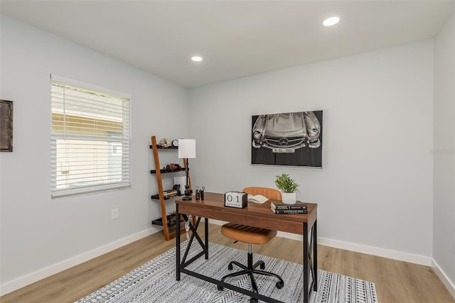 home office with light hardwood / wood-style floors