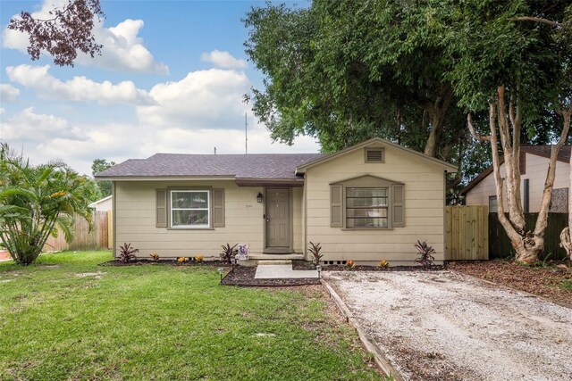 ranch-style home featuring a front yard