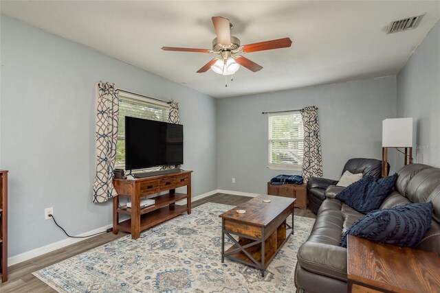 living room with ceiling fan and hardwood / wood-style floors