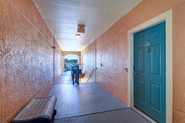 hallway with a textured ceiling