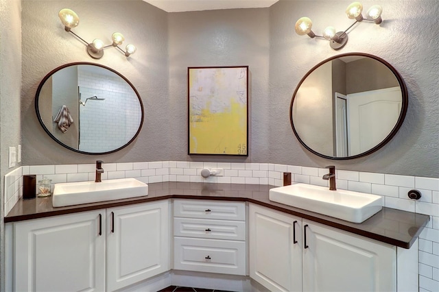 bathroom with tasteful backsplash and vanity