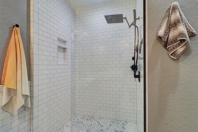 bathroom featuring a tile shower