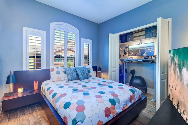 bedroom featuring dark wood-type flooring and a closet