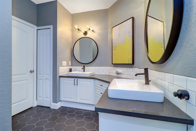 bathroom featuring vanity, backsplash, and tile patterned flooring