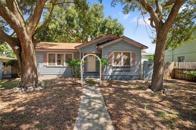 view of front facade featuring crawl space and fence