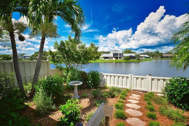 view of yard featuring a water view and fence
