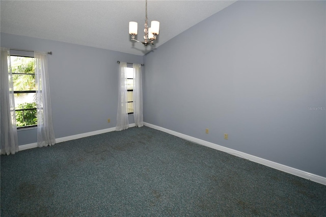 carpeted empty room featuring lofted ceiling, a healthy amount of sunlight, an inviting chandelier, and a textured ceiling