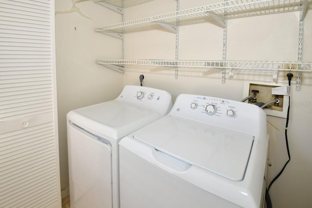 washroom featuring washer and dryer and laundry area