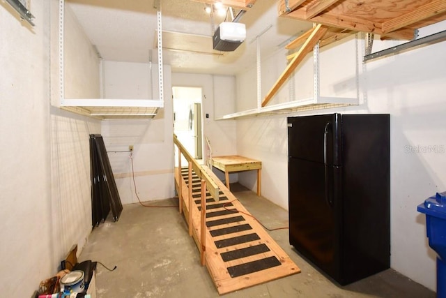 below grade area featuring freestanding refrigerator