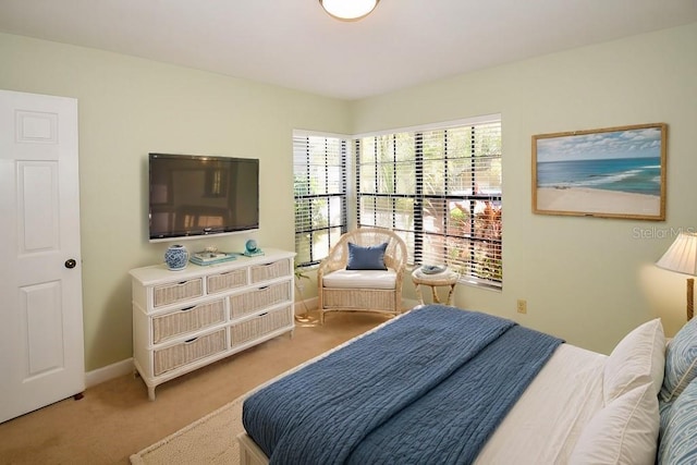 bedroom featuring light colored carpet