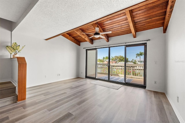 interior space with wood ceiling, a textured ceiling, ceiling fan, lofted ceiling with beams, and light hardwood / wood-style floors