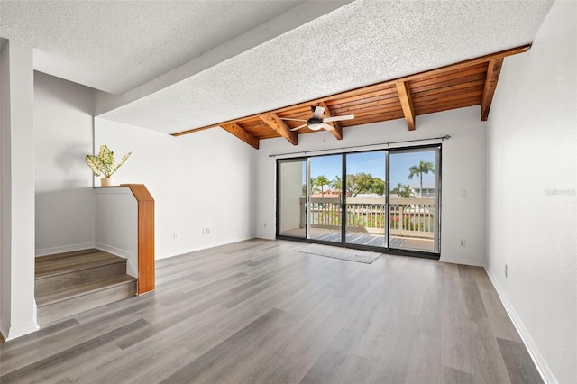 unfurnished living room featuring a textured ceiling, wood finished floors, wood ceiling, and baseboards