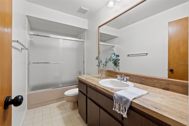 full bathroom featuring vanity, toilet, tile patterned floors, and enclosed tub / shower combo