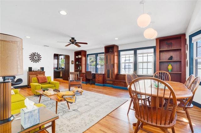 living room featuring light hardwood / wood-style floors and ceiling fan