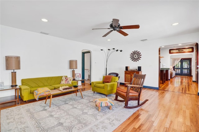 living room featuring ceiling fan and light wood-type flooring