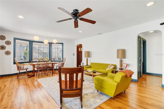 living room featuring light hardwood / wood-style floors and ceiling fan