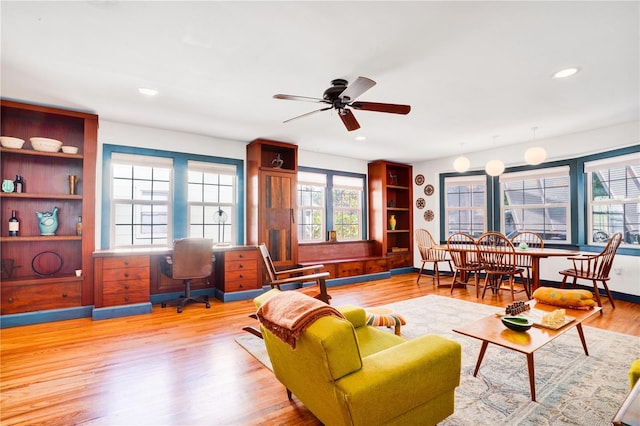 living room with ceiling fan and hardwood / wood-style flooring