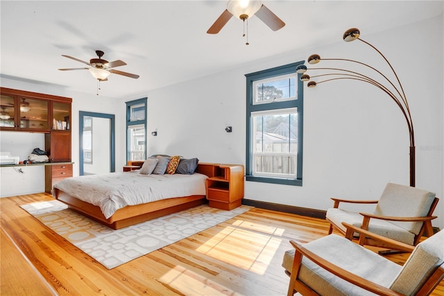 bedroom featuring light hardwood / wood-style floors and ceiling fan