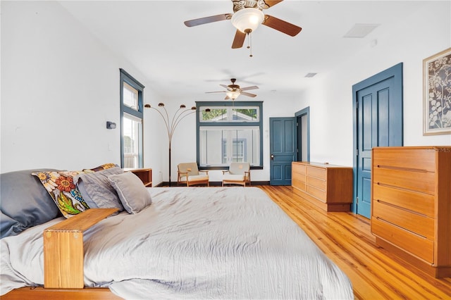 bedroom featuring light hardwood / wood-style floors and ceiling fan