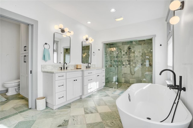 full bathroom featuring independent shower and bath, vanity, and toilet