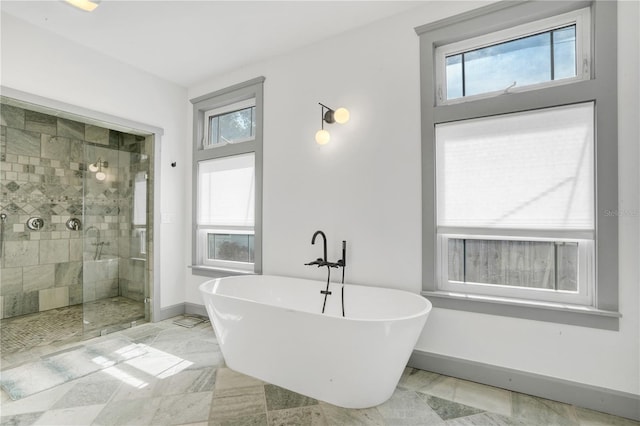 bathroom featuring separate shower and tub