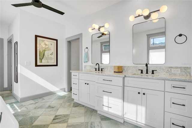 bathroom with a bath, vanity, and ceiling fan