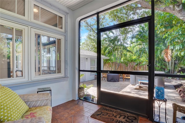 sunroom / solarium featuring a healthy amount of sunlight