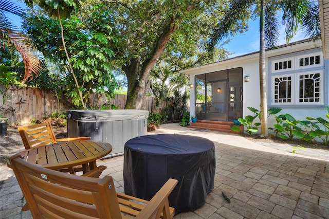 view of patio / terrace with a hot tub