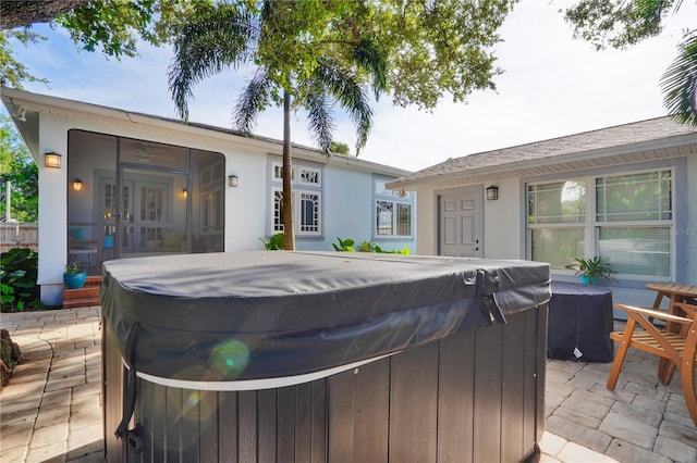 back of house featuring french doors, a patio, and a hot tub