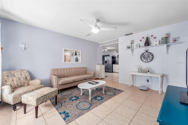 living room featuring light tile patterned floors and ceiling fan