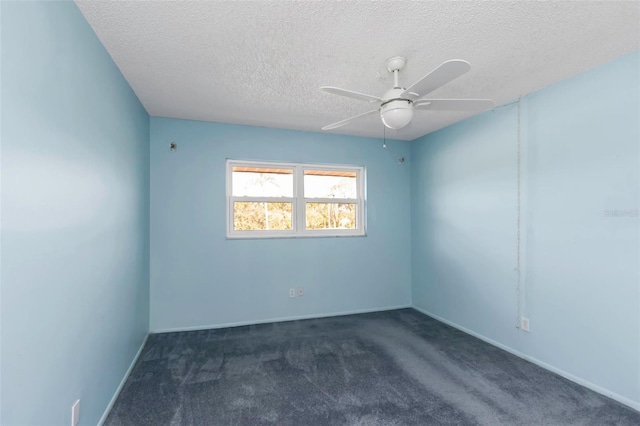 carpeted spare room with ceiling fan and a textured ceiling