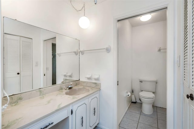 bathroom featuring vanity, toilet, and tile patterned floors